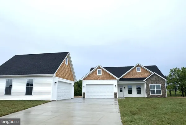 a kitchen with stainless steel appliances granite countertop a refrigerator a stove a sink and white cabinets