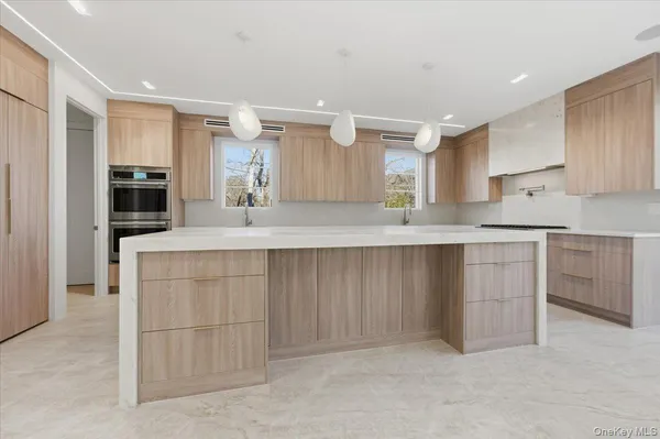 a large kitchen with cabinets and a stainless steel appliances