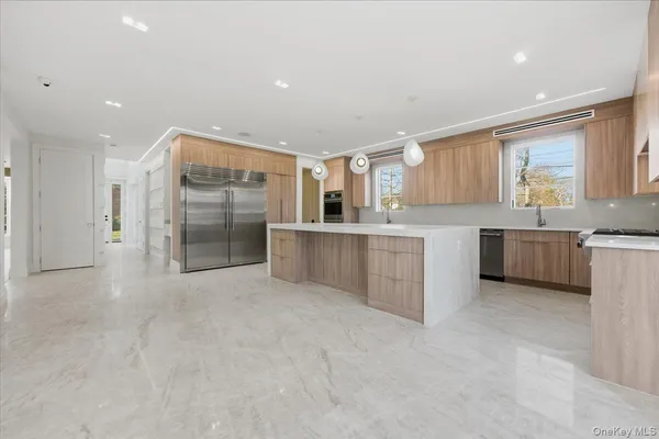 a kitchen with a sink refrigerator and cabinets