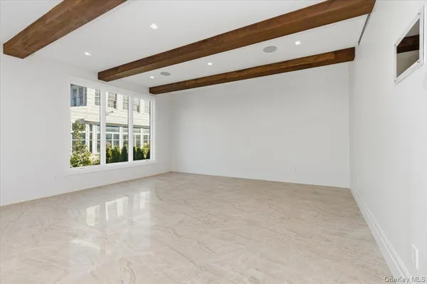 en empty room with wooden floor and furniture