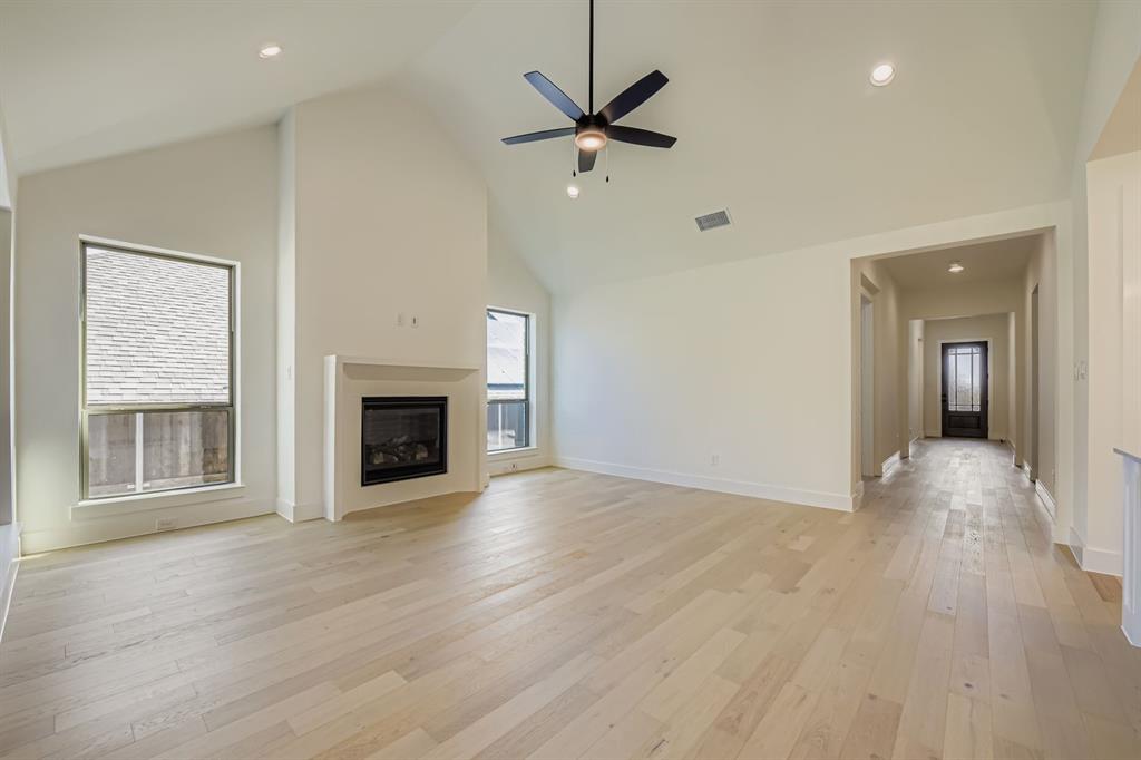 138 Sandie Drive Rhome, TX 76078 - Photo 5 of 28 a view of a livingroom with a fireplace a ceiling fan and wooden floor