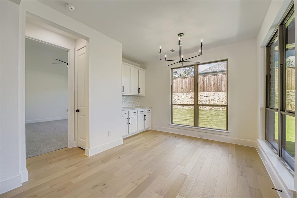138 Sandie Drive Rhome, TX 76078 - Photo 8 of 28 wooden floor in an empty room with a window
