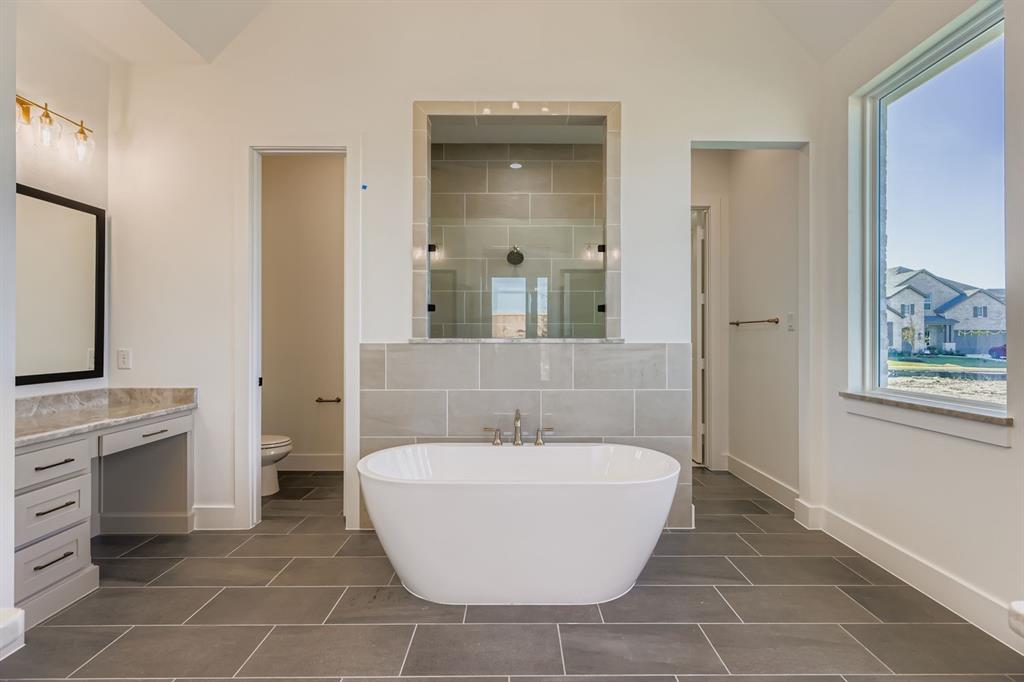 2730 Savannah Ridge Prosper, TX 75078 - Photo 11 of 28 a bathroom with a bathtub and a sink