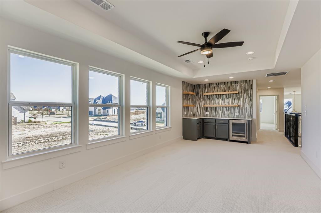 2730 Savannah Ridge Prosper, TX 75078 - Photo 21 of 28 a view of a livingroom with a ceiling fan and window