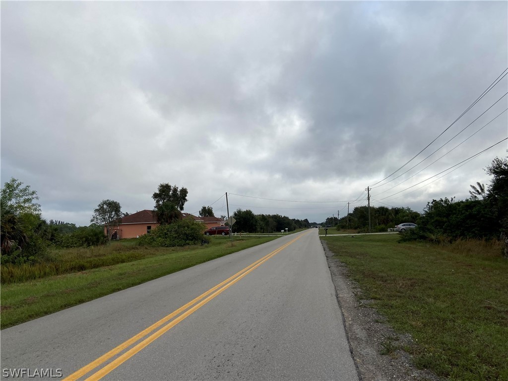 2205 Park Road Lehigh Acres, FL 33971 - Photo 6 of 7 a view of a lake with a big yard