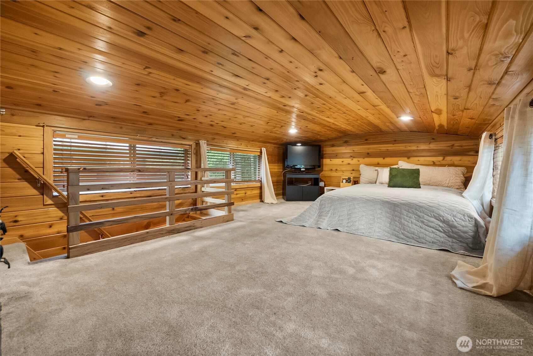 1546 Reservation Road Southeast, Unit 149 Olympia, WA 98513 - Photo 17 of 38 a bedroom with a large bed and a chandelier