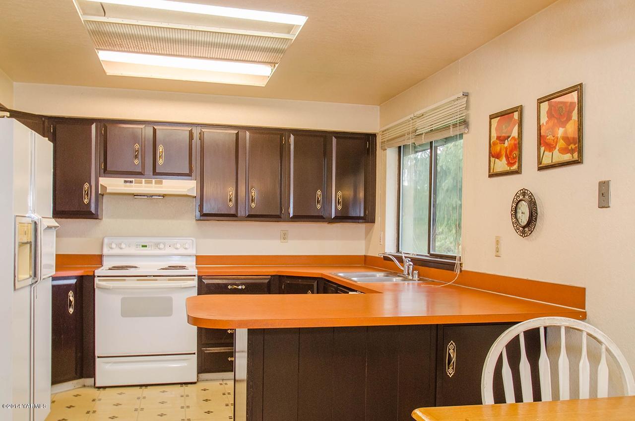 12605 Douglas Road Yakima, WA 98908 - Photo 4 of 10 a kitchen that has a cabinets and a stove