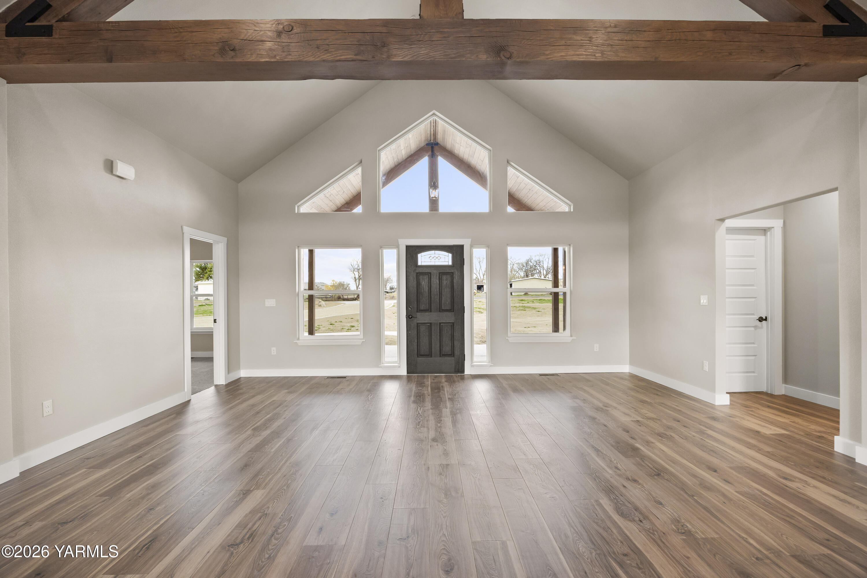 6133 South Moore Road Prosser, WA 99350 - Photo 11 of 54 an empty room with wooden floor and windows