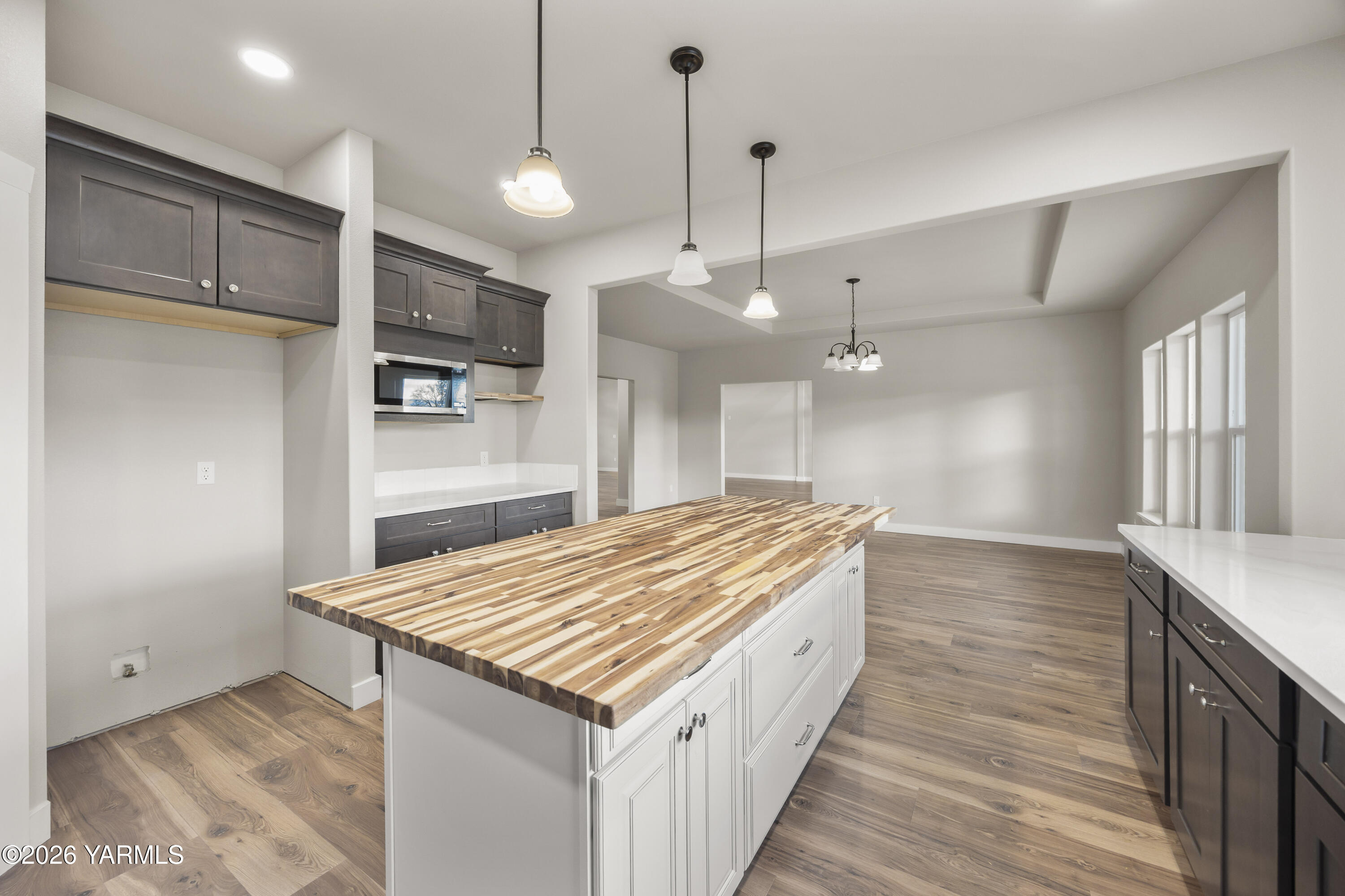 6133 South Moore Road Prosser, WA 99350 - Photo 12 of 54 a kitchen with kitchen island a sink stove and wooden floor