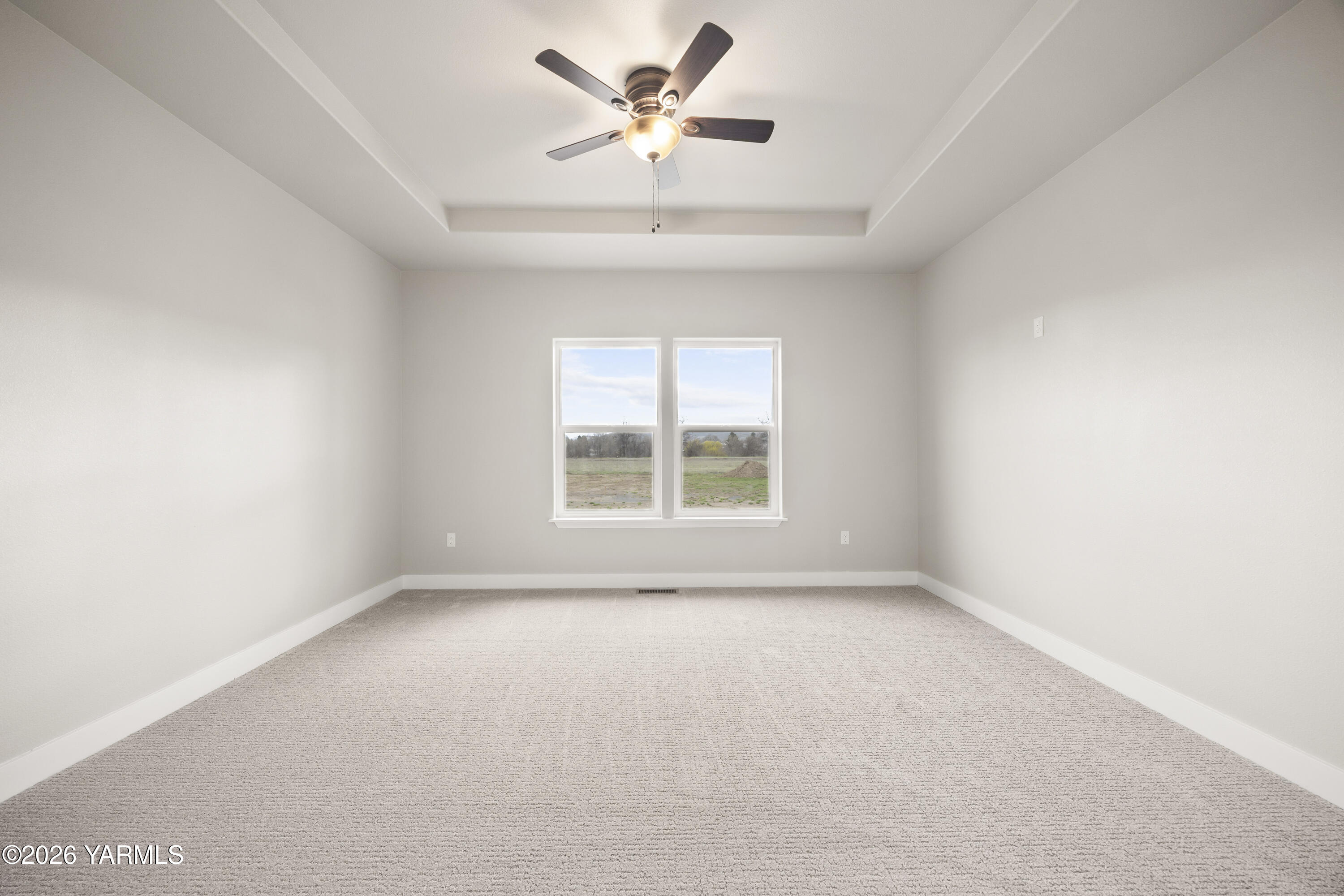 6133 South Moore Road Prosser, WA 99350 - Photo 6 of 54 an empty room with a window and a fan