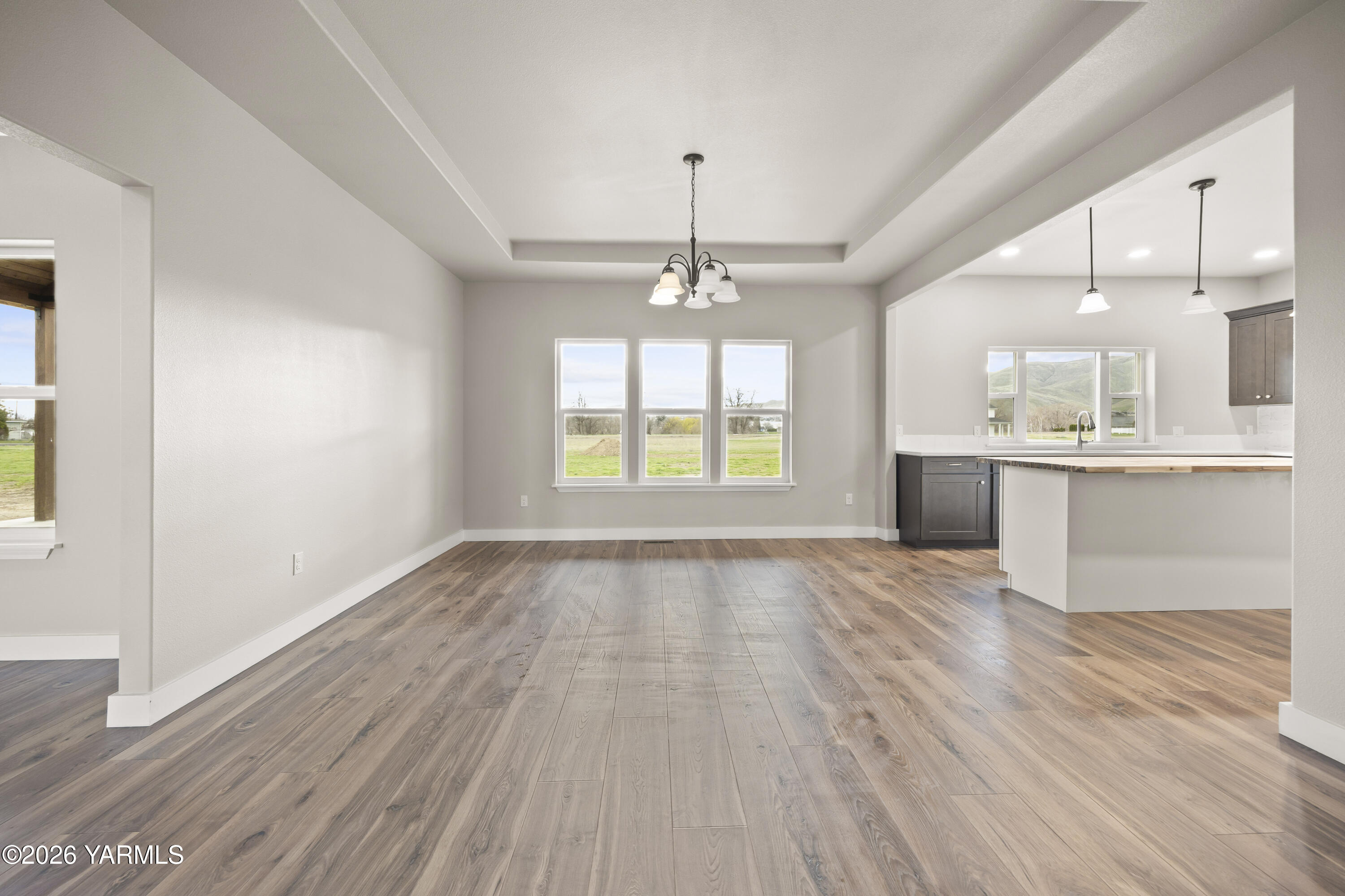 6133 South Moore Road Prosser, WA 99350 - Photo 8 of 54 an empty room with wooden floor and windows