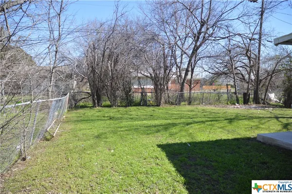 a view of a park with large trees