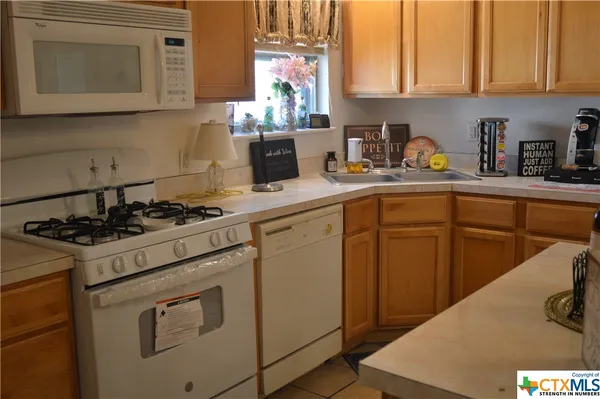 a kitchen with cabinets appliances and a sink