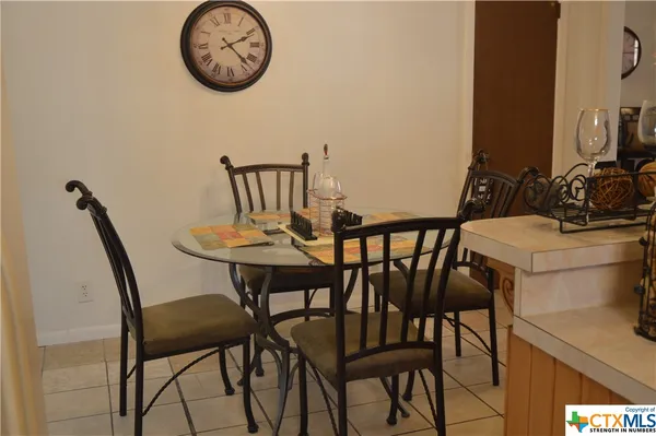 a view of a dining room with furniture and front door