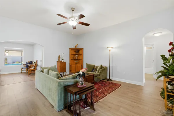 a living room with furniture and wooden floor