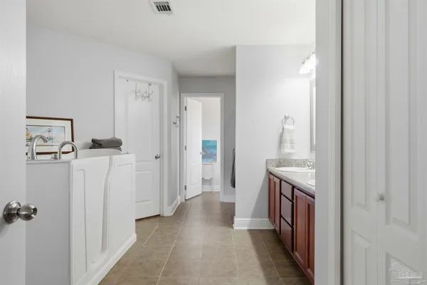a bathroom with a granite countertop sink a toilet and a mirror