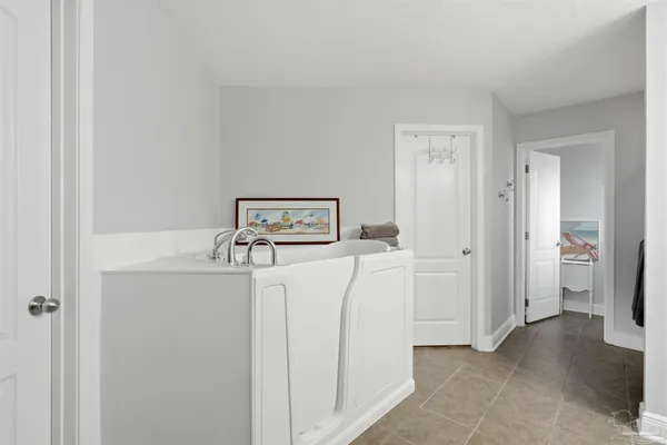 a bathroom with a granite countertop sink a toilet and a mirror