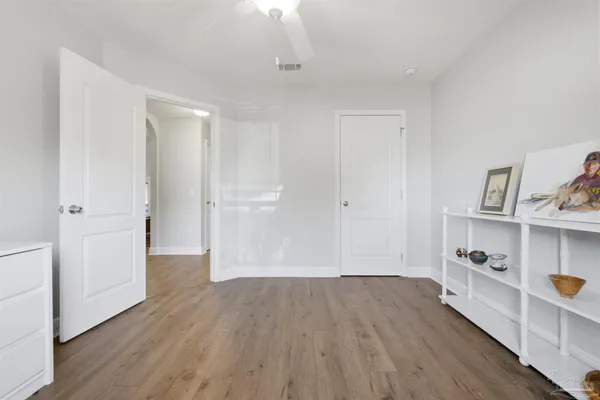 a view of a room with wooden floor and closet
