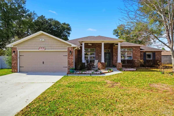 a view of a house with a yard patio and fire pit