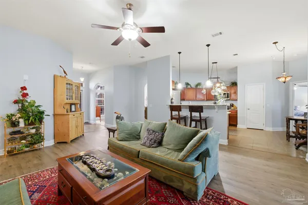 a living room with furniture and a chandelier