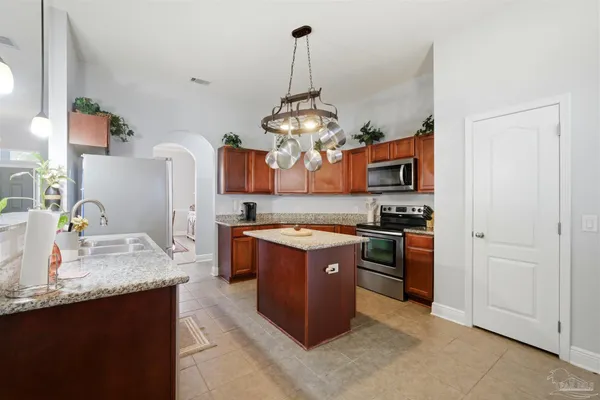 a kitchen with stainless steel appliances granite countertop a stove and a sink