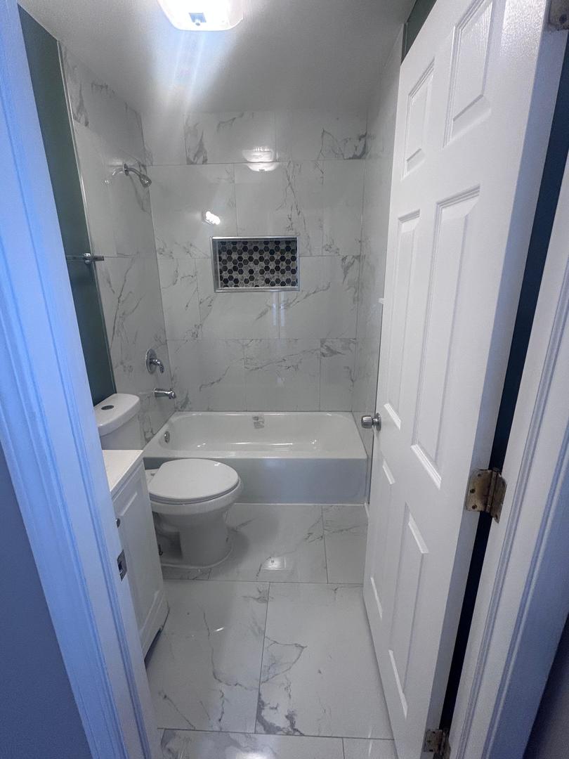 5905 South Indiana Avenue, Unit 1 Chicago, IL 60637 - Photo 7 of 13 a bathroom with a sink a toilet and shower