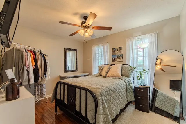 a bedroom with a bed and a flat screen tv