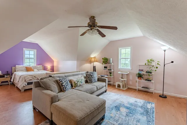 a living room with furniture and wooden floor