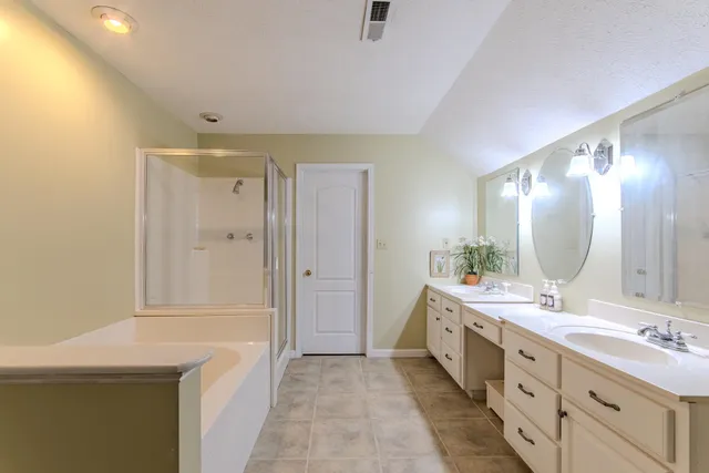 a view of a hallway with wooden floor and stairs