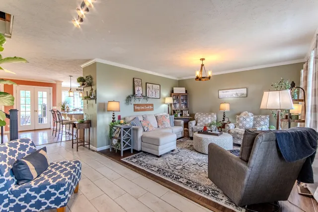 a living room with furniture and a chandelier