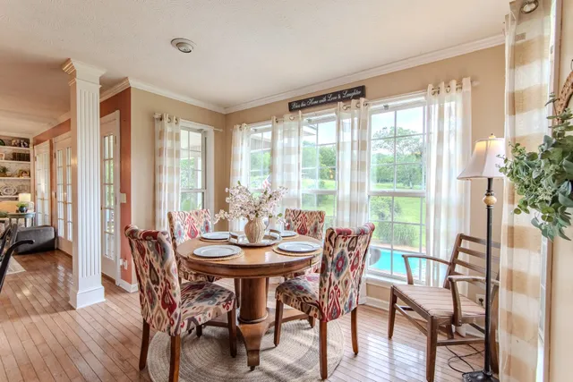 a view of a dining room with furniture window and wooden floor