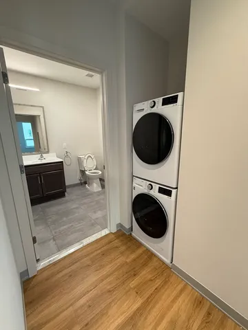 a bedroom with a bed and a washing machine