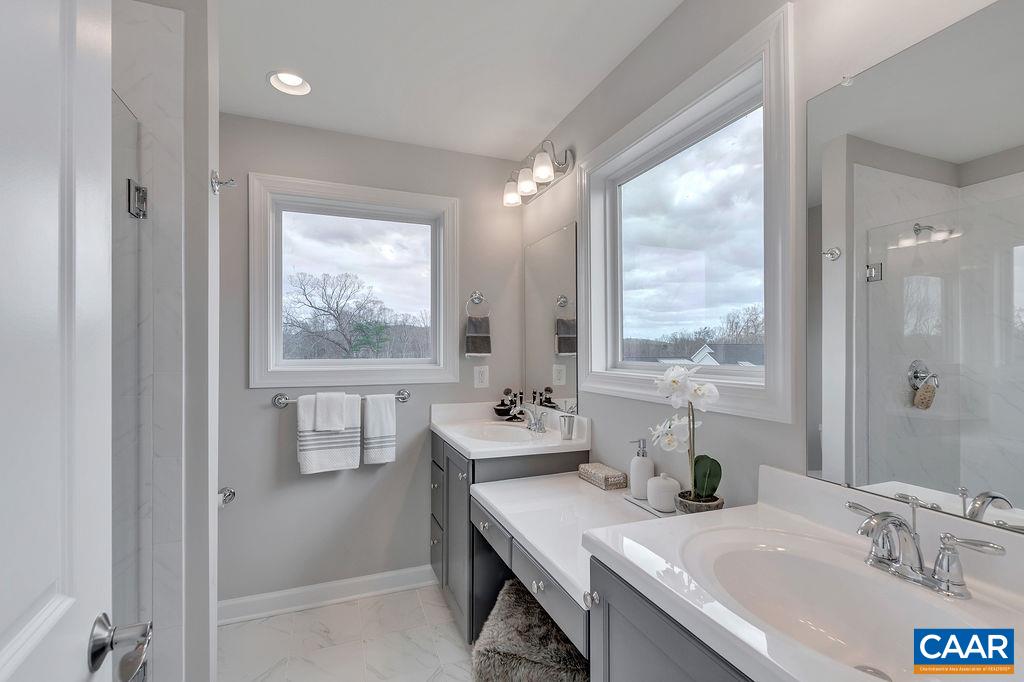 3197 Horizon Road Charlottesville, VA 22902 - Photo 18 of 27 a bathroom with a sink vanity tub and a mirror
