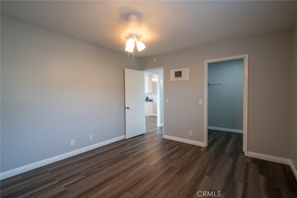 445 Garrison Street Oceanside, CA 92054 - Photo 10 of 12 an empty room with wooden floor and windows