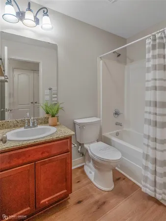 an empty room with a chandelier fan and windows