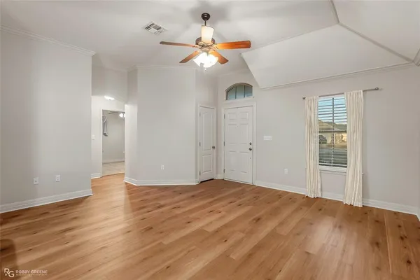 wooden floor in an empty room with a window