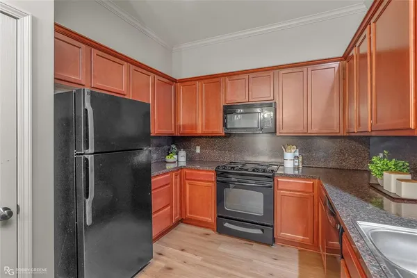 a kitchen with stainless steel appliances granite countertop a refrigerator and a stove top oven