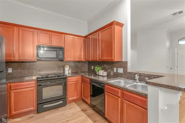 a kitchen with stainless steel appliances granite countertop a sink stove and microwave
