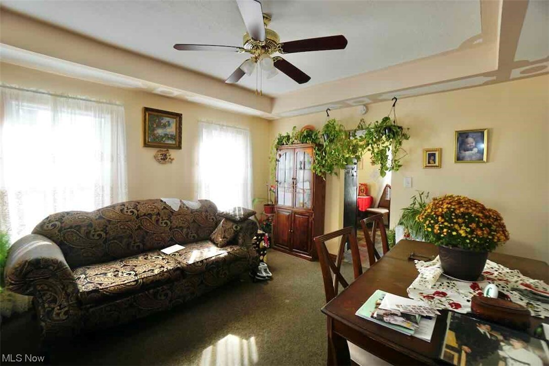 3756 Bosworth Road Cleveland, OH 44111 - Photo 7 of 23 Living room with a tray ceiling, ceiling fan, and carpet