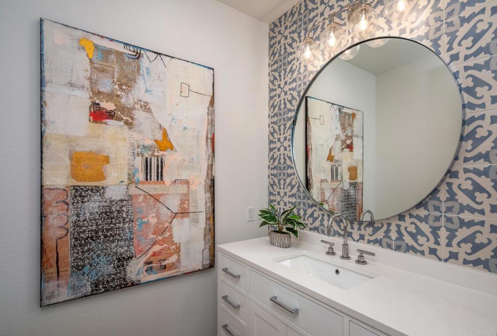 667 Lynwood Drive Encinitas, CA 92024 - Photo 18 of 36 a bathroom with a sink mirror and vanity