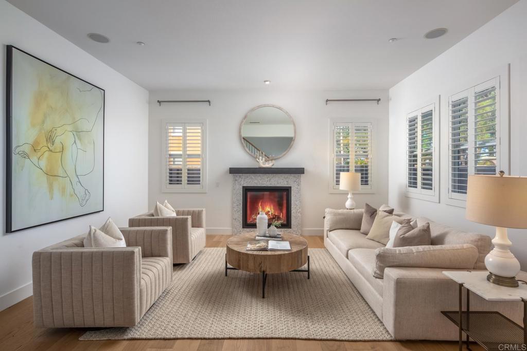 667 Lynwood Drive Encinitas, CA 92024 - Photo 7 of 36 a living room with furniture two windows and a fireplace