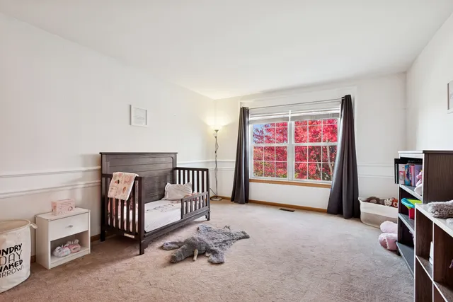 a spacious bedroom with a bed and a tv in it