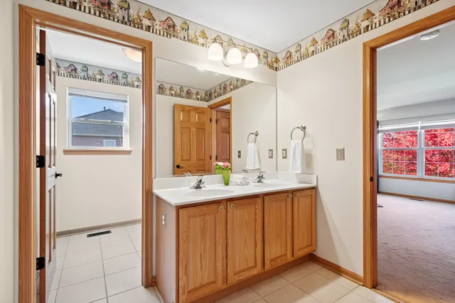 a bathroom with a double vanity sink mirror and