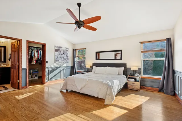 a bedroom with a large bed and a chandelier