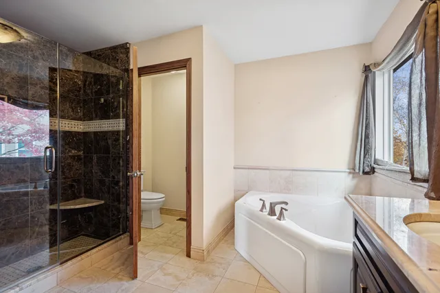 a bathroom with a bathtub and a shower