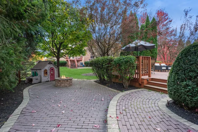 a view of a house with a yard and a patio