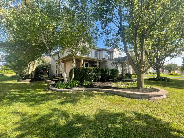 a view of a house with swimming pool and sitting area