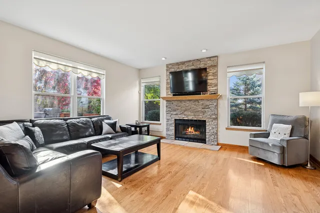 a living room with furniture a flat screen tv and a fireplace