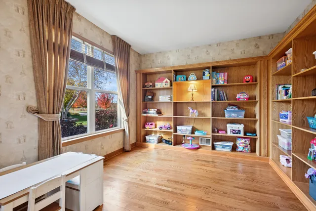 a room with lots of books and a large window