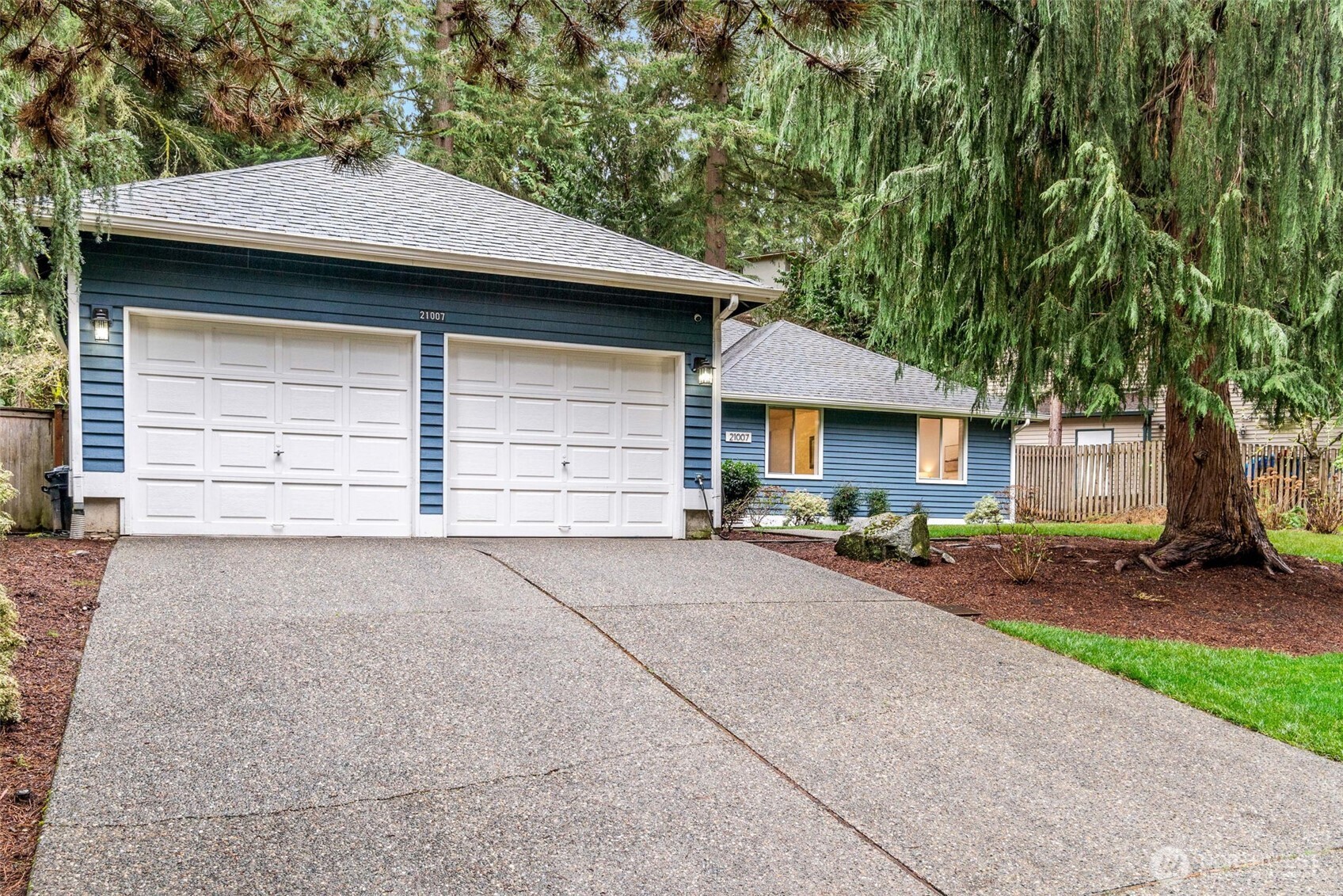 21007 Pioneer Way Edmonds, WA 98026 - Photo 27 of 27 a front view of a house with a yard and garage